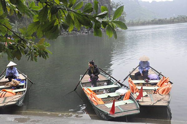 Under the Sao Khe River near Tam Coc Ninh Binh, small boats quietly parked close to each other. around the wharf.